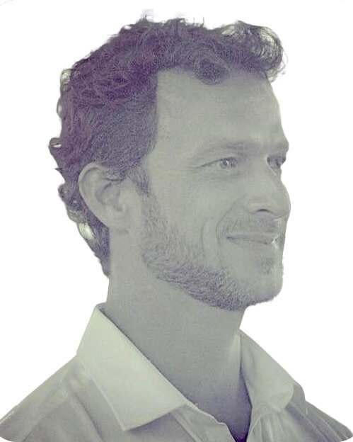 A portrait of Dr. Tiago Arruda with curly hair.